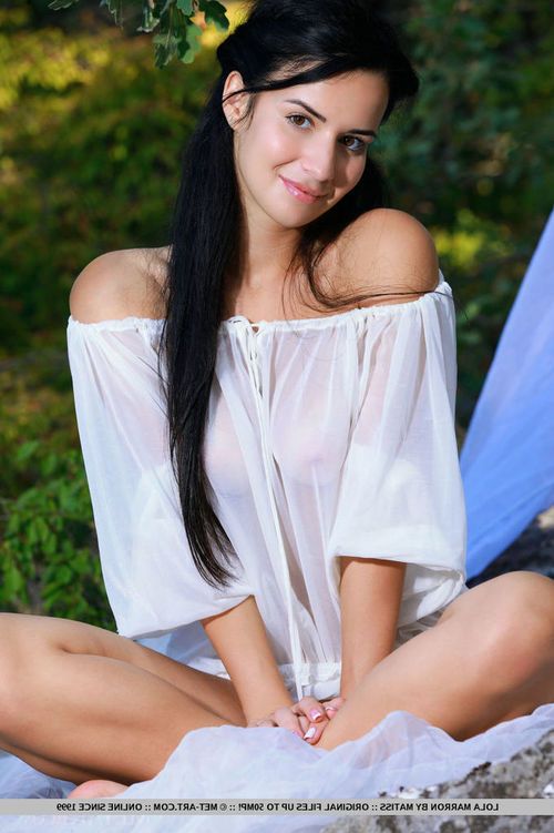 Attractive raven-haired teenager Lola spreads her long sexy legs