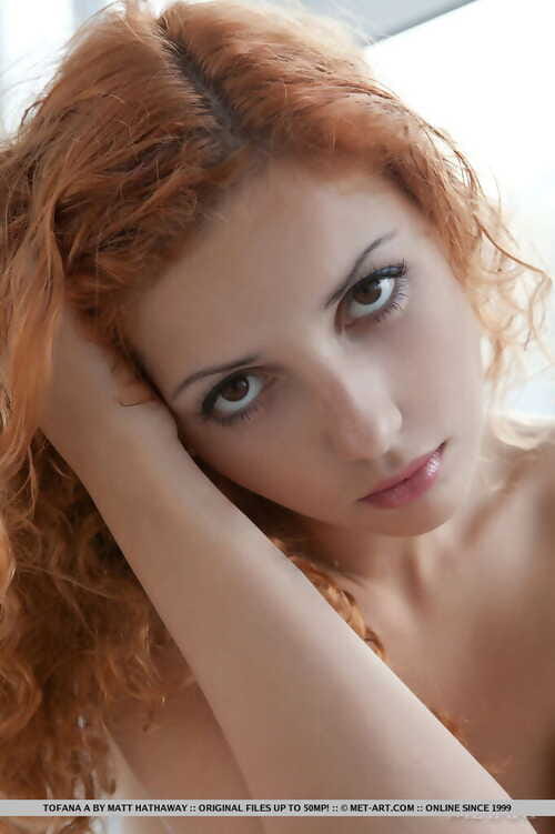 Lusty ginger young Tofana enjoys unveiling her cleanly shaved pink slit