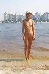 Naked teens play together at a public beach