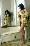 Short haired dark brown can\'t live without self in mirror during sheltered solely in a mink coat.