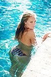 Blond European centerfold hotty Kristy Garett baring sensible bazookas beside pool