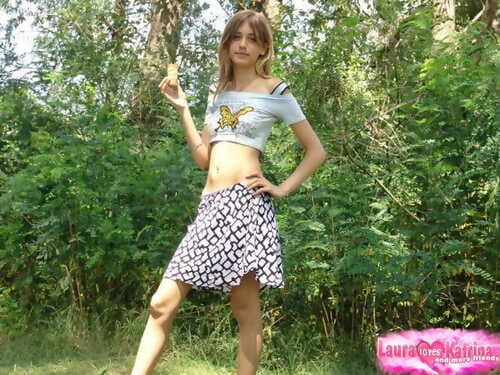 Shapely juvenile youthful in small t-shirt and petticoat posing outdoors