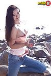 Teen-age year old doll Olivia baring shiny on top young fur pie outdoors on beach