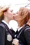 Adolescent schoolgirls Cali Sparks and Kelly Greene tongue giving a kiss outdoors