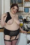 Extra-weighed british housewife playing in her kitchen