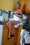 Ripened blond lady Cathy Oakley baring her milk cans in kitchen