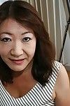 Eastern grandpa Michiko Okawa undressing and exposing her shaggy vagina in close up